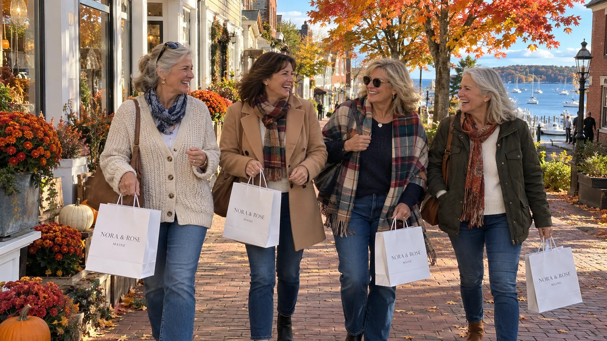 Four women walking through a Maine town with Nora & Rose shopping bags